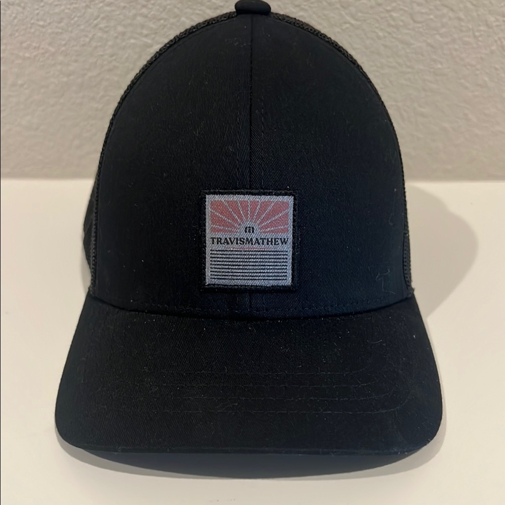 TravisMathew trucker Black Cap with Logo Patch